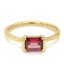 A yellow gold ring featuring a rectangular emerald-cut red gemstone in a prong setting, shown against a plain white background.