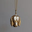 Gold dog-shaped pendant on a chain against a gray background