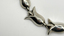 silver necklace with tulip shaped links on white background