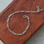 Silver chain bracelet on a wooden surface