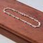 Silver chain on a wooden surface