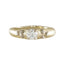 A yellow gold ring featuring a central round-cut clear gemstone flanked by smaller cluster settings on either side, shown against a plain white background.